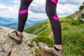 Legs of a girl in mountain boots on a background of beautiful mountains. Close-up. Hiking. Leisure Royalty Free Stock Photo