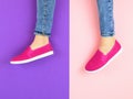 Legs of the girl in red sneakers and jeans on the purple and pink floor. The view from the top. Royalty Free Stock Photo