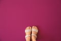 Legs of girl wearing sandals on color background Royalty Free Stock Photo