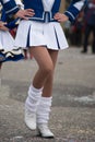 legs of girls with sexy costume of cheerleader parading in the street Royalty Free Stock Photo