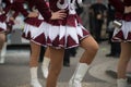 legs of girls with sexy costume of cheerleader parading in the street Royalty Free Stock Photo