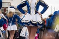 Legs of girls with sexy costume of cheerleader parading in the street Royalty Free Stock Photo