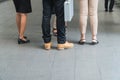 Legs of a group of businessmen standing in overpass bridge