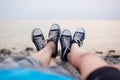 The legs of a guy and a girl in the evening on the beach Royalty Free Stock Photo