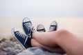 The legs of a guy and a girl in the evening on the beach Royalty Free Stock Photo