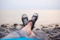 The legs of a guy in sneakers on the beach Royalty Free Stock Photo