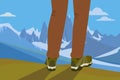 Legs of hiker on top of a hill looking at snowy mountains Royalty Free Stock Photo