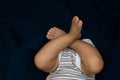 Legs on an infant on blue background