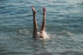 Legs of a little bather girl in the sea.