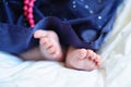 Legs little girl on a background of white sheets