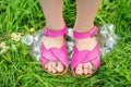 Legs of a little girl tramples a plastic bottle Royalty Free Stock Photo