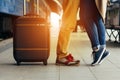 Legs Loving Couple happy hugging in the train station of a country after arrival in autumn with a warm sunlight Royalty Free Stock Photo