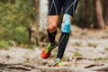 legs male runner with kinesio tape on knee running forest trail marathon Royalty Free Stock Photo