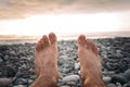 Legs of man on the beach at sunset Royalty Free Stock Photo