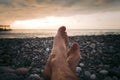 Legs of man on the beach at sunset Royalty Free Stock Photo