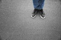 Legs of man in casual shoes on asphalt Royalty Free Stock Photo