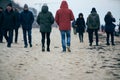 The legs of a man in jeans and boots are walking along a dusty road. A working man goes to a factory or a construction site. Royalty Free Stock Photo