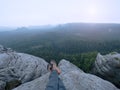 Legs of a man on rock. Hiker resting in boots for mountain Royalty Free Stock Photo