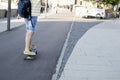 The legs of a man in sneakers, who rides a skateboard at the Museon in Moscow