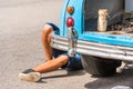 The legs of a man under the car, Vinales, Pinar del Rio, Cuba. Car repairs. Close-up. Royalty Free Stock Photo