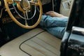 the legs of a man and a woman near the helm of the car. people lie on the seats in the car. Royalty Free Stock Photo