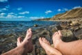 Legs of man and woman relaxing on a sea Royalty Free Stock Photo