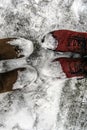 Legs Man and woman in warm winter shoes standing in the snow next to each other. Close-up feet of couple stand on snow on winter Royalty Free Stock Photo