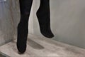 Legs of a mannequin in black pantyhose