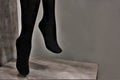 Legs of a mannequin in black pantyhose