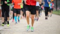 Legs of runners at footrace race in the city