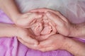 Legs of a newborn baby in the arms of his parents, mom and dad Royalty Free Stock Photo