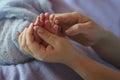 The legs of a newborn baby in the hands of mother Royalty Free Stock Photo