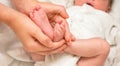 Legs newborn in sister hand