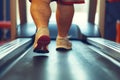 Legs of overweight person run on treadmill in gym