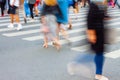 Legs of people in the crowd crossing the road. People without faces in the city