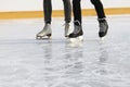 Legs people together skating on the ice rink