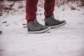 legs of a person standing on the snow path at winter close up Royalty Free Stock Photo