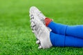 Legs of a player in football on a green lawn Royalty Free Stock Photo