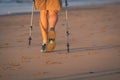 Legs and poles of nordic walker old woman Royalty Free Stock Photo