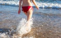 Legs of a pretty girl walking in a sea Royalty Free Stock Photo