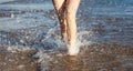 Legs of a pretty girl walking in a sea Royalty Free Stock Photo