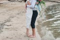 Legs pretty strong young loving couple on the beach over the river