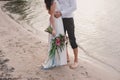 Legs pretty strong young loving couple on the beach over the river