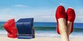 Legs with red cloth shoes in front of beach Royalty Free Stock Photo