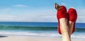 Legs with red cloth shoes in front of beach Royalty Free Stock Photo