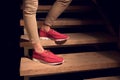 Legs with a red leather moccasins on a stairs