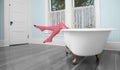 Striped legs over bath tub in vintage bathroom