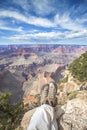 Legs of a resting person on the edge of the Grand Canyon.