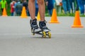 Legs in roller skates skating on road Royalty Free Stock Photo
