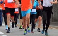 legs of runners running in group during foot race